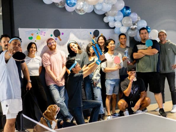 Teammates cheering during the ping pong tournament
